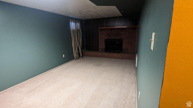 252 N Highland Dr, Cedar City, UT 84721 - unfurnished living room featuring a fireplace, wooden walls, and carpet flooring