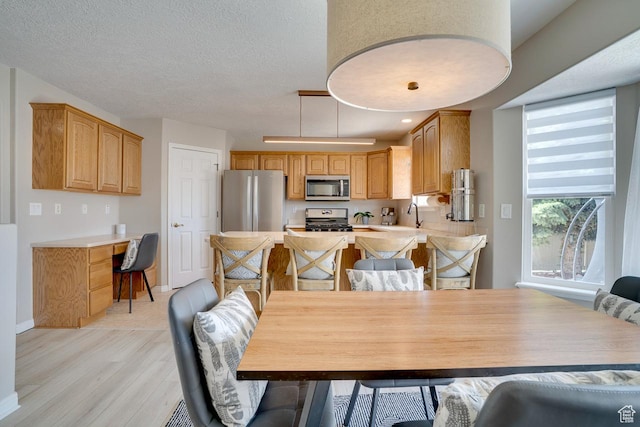 676 S 620 E, Heber City, UT 84032 - dining room with light wood finished floors, baseboards, and a textured ceiling