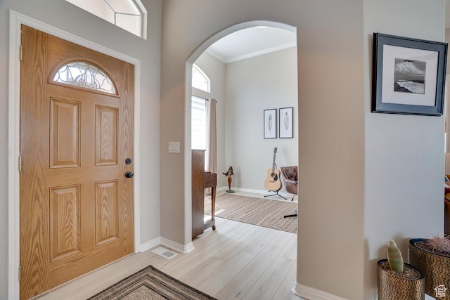 676 S 620 E, Heber City, UT 84032 - entrance foyer featuring arched walkways, light wood-type flooring, crown molding, and baseboards