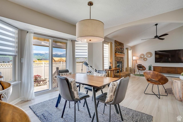 676 S 620 E, Heber City, UT 84032 - dining space with plenty of natural light, light wood-style floors, ceiling fan, a fireplace, and vaulted ceiling