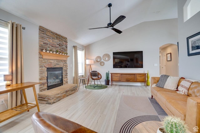 676 S 620 E, Heber City, UT 84032 - living area with vaulted ceiling, ceiling fan, arched walkways, light wood-style flooring, and a stone fireplace