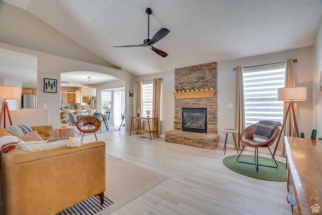 676 S 620 E, Heber City, UT 84032 - living room with ceiling fan, arched walkways, light wood-style flooring, vaulted ceiling, and a fireplace