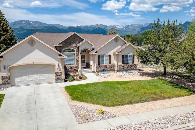 676 S 620 E, Heber City, UT 84032 - view of front of home with stone siding, a mountain view, stucco siding, an attached garage, and concrete driveway