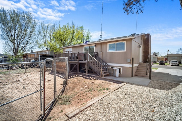 537 E 650 N, Roosevelt, UT 84066 - view of front of home featuring stairs, a chimney, a gate, a deck, and fence