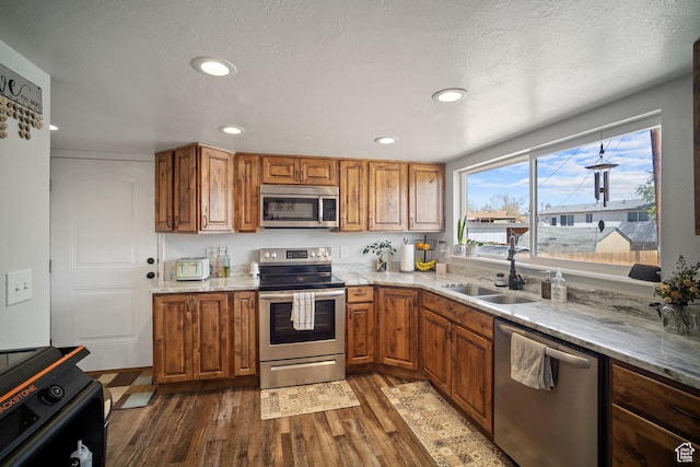 537 E 650 N, Roosevelt, UT 84066 - kitchen featuring appliances with stainless steel finishes, brown cabinets, dark wood-style floors, and a sink