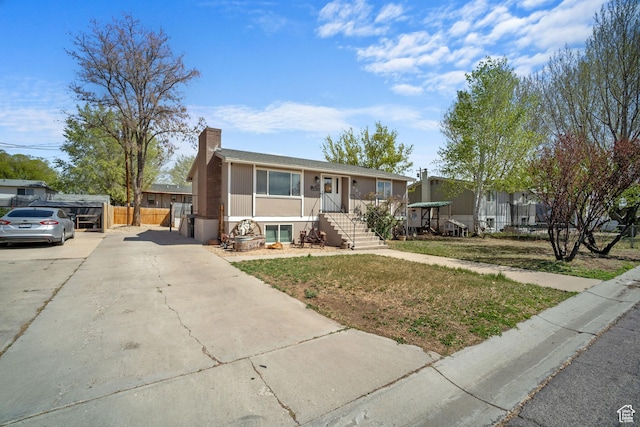537 E 650 N, Roosevelt, UT 84066 - view of front of house with concrete driveway, fence, and a chimney