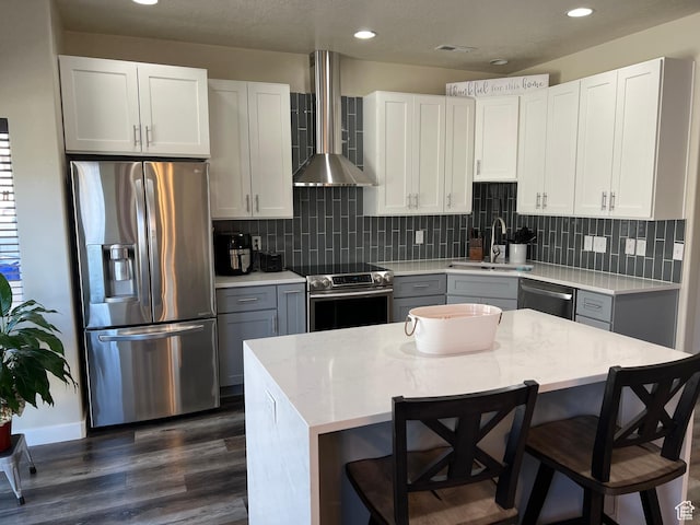272 W 680 N, Centerville, UT 84014 - kitchen with a sink, stainless steel appliances, a kitchen breakfast bar, wall chimney exhaust hood, and dark wood finished floors