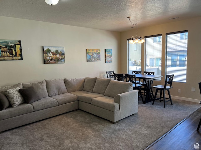 272 W 680 N, Centerville, UT 84014 - living area featuring wood finished floors, a textured ceiling, a wealth of natural light, and a chandelier