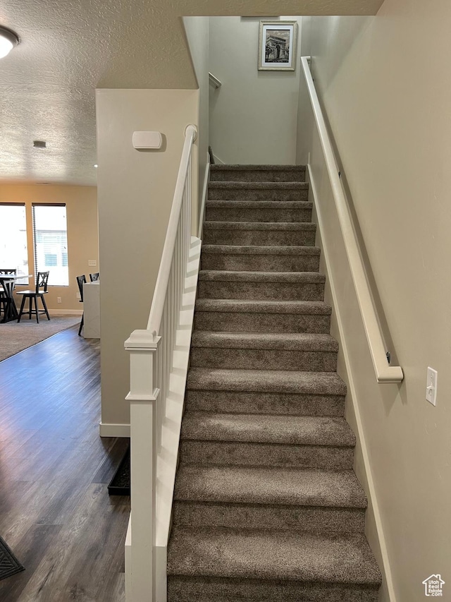 272 W 680 N, Centerville, UT 84014 - stairs with a textured ceiling, wood finished floors, and baseboards