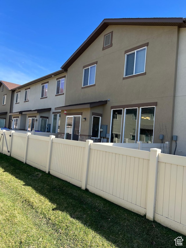 272 W 680 N, Centerville, UT 84014 - back of property with fence, stucco siding, and a lawn