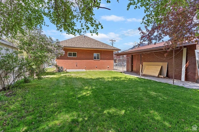 view of yard featuring a garage and fence