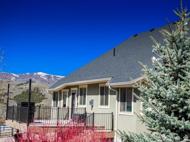 4718 E Cougar Run S, Ut, UT 84629 - exterior space with stucco siding, roof with shingles, fence, and a mountain view