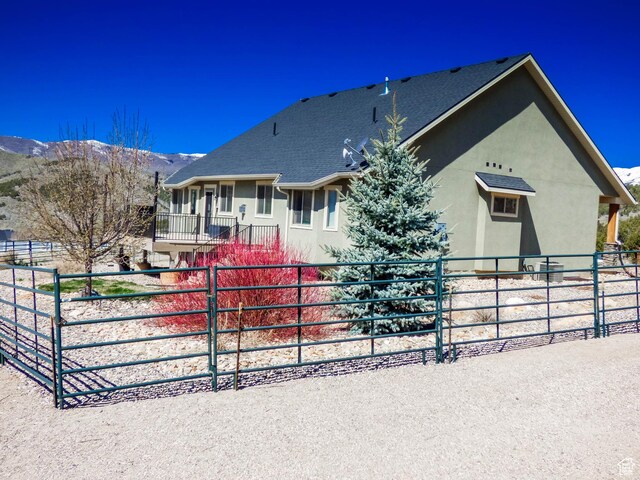 4718 E Cougar Run S, Ut, UT 84629 - view of front of property with a shingled roof, stucco siding, and fence