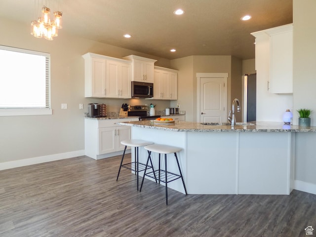 4718 E Cougar Run S, Ut, UT 84629 - kitchen featuring white cabinetry, light stone counters, a peninsula, appliances with stainless steel finishes, and dark wood finished floors