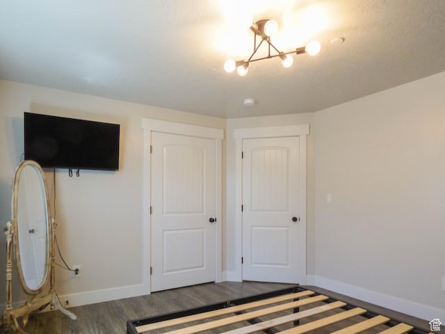4718 E Cougar Run S, Ut, UT 84629 - unfurnished bedroom featuring baseboards, wood finished floors, and an inviting chandelier