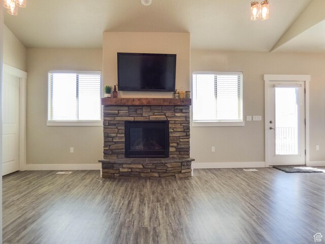 4718 E Cougar Run S, Ut, UT 84629 - unfurnished living room with an inviting chandelier, wood finished floors, a stone fireplace, and baseboards