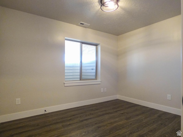 4718 E Cougar Run S, Ut, UT 84629 - unfurnished room with baseboards, visible vents, a textured ceiling, and dark wood-type flooring