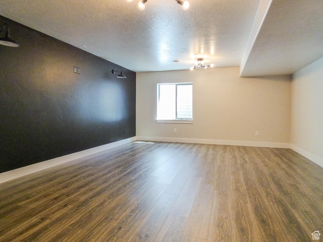 4718 E Cougar Run S, Ut, UT 84629 - empty room featuring a textured ceiling, wood finished floors, and baseboards
