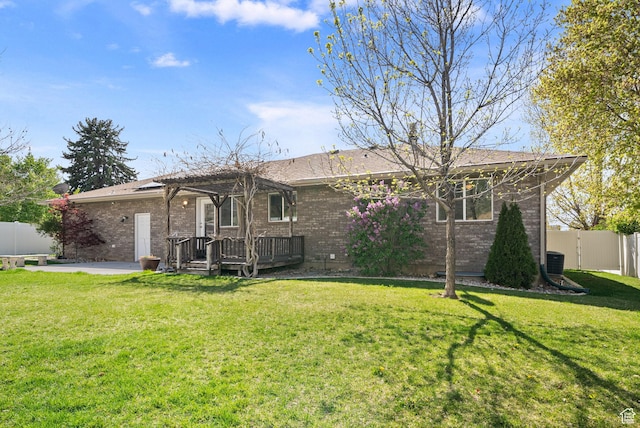 428 N 100 W, Santaquin, UT 84655 - rear view of property featuring a deck, brick siding, a fenced backyard, and a yard