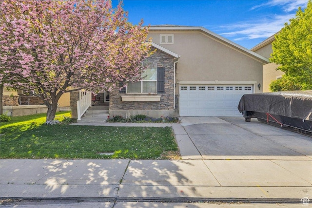 obstructed view of property featuring concrete driveway, stone siding, a front yard, an attached garage, and stucco siding