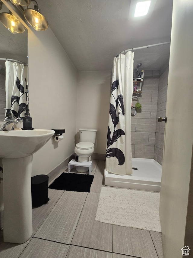 5841 S 129 W, Murray, UT 84107 - bathroom with a stall shower, toilet, baseboards, and wood finished floors