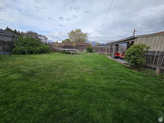 5841 S 129 W, Murray, UT 84107 - view of yard with a trampoline and a fenced backyard