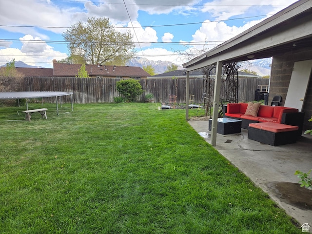 5841 S 129 W, Murray, UT 84107 - view of yard featuring a fenced backyard, a trampoline, a patio, and outdoor lounge area