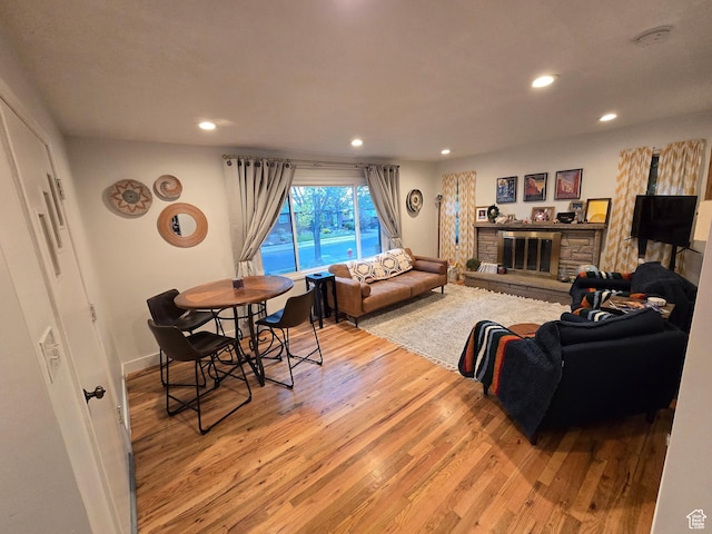 5841 S 129 W, Murray, UT 84107 - living room featuring a fireplace, light wood-style flooring, and recessed lighting