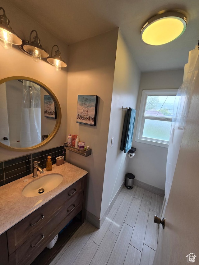 5841 S 129 W, Murray, UT 84107 - full bathroom featuring tasteful backsplash, vanity, wood finish floors, a shower with shower curtain, and baseboards