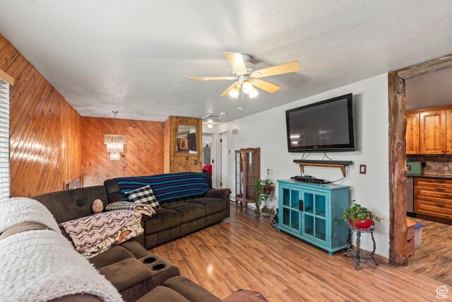 3168 W 1300 N, Clinton, UT 84015 - living area with wooden walls, light wood-type flooring, and a ceiling fan