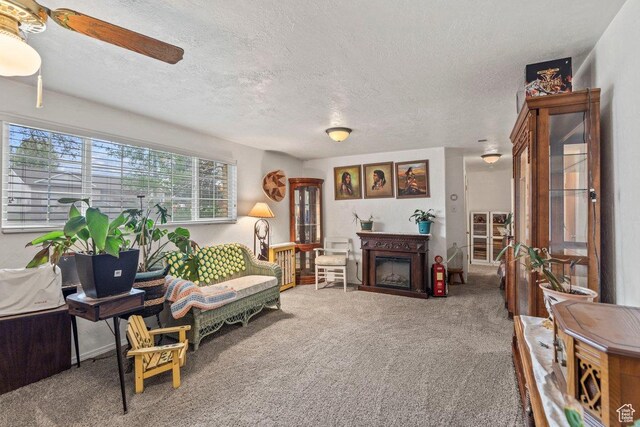 3168 W 1300 N, Clinton, UT 84015 - carpeted living area featuring a textured ceiling, ceiling fan, and a fireplace