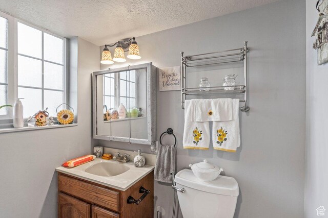 3168 W 1300 N, Clinton, UT 84015 - half bathroom featuring toilet, a textured ceiling, and vanity