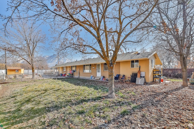 4222 S 1100 E, Millcreek, UT 84124 - back of property featuring brick siding, a fenced backyard, and a yard