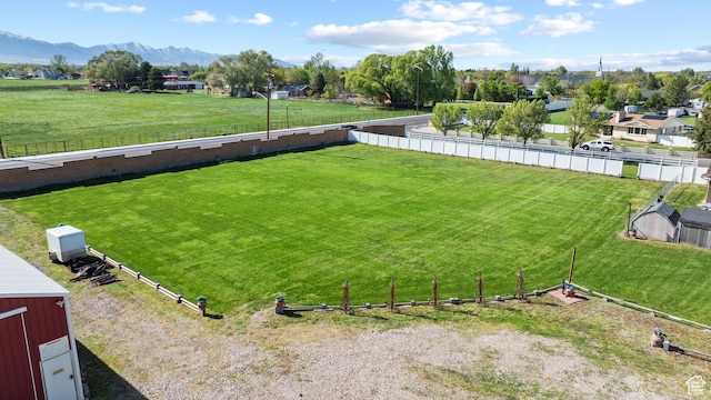 view of yard with a mountain view, fence, and a rural view