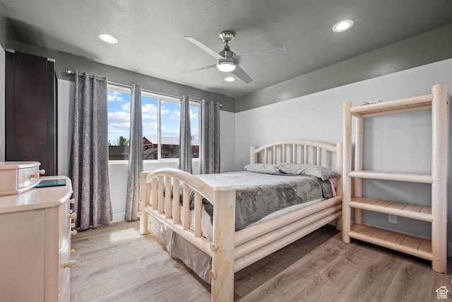 bedroom featuring light wood finished floors and recessed lighting