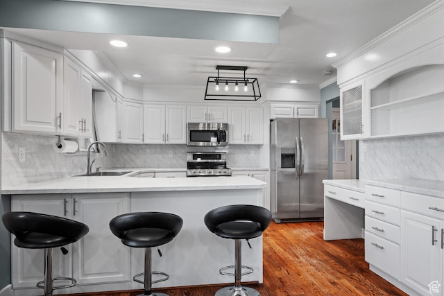 kitchen featuring a sink, stainless steel appliances, open shelves, a peninsula, and white cabinets
