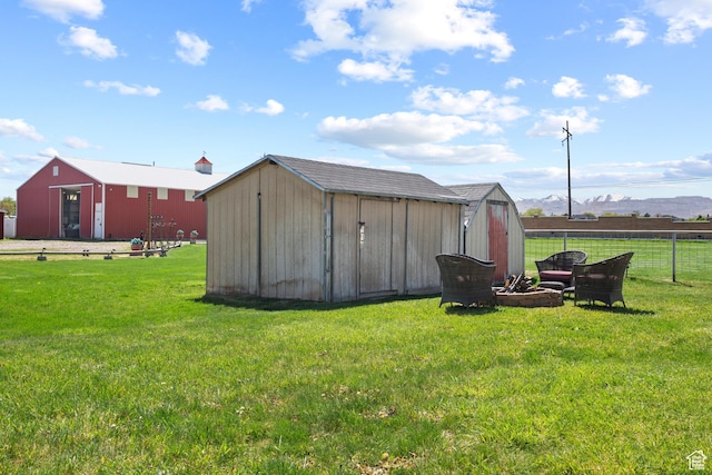 view of shed featuring a mountain view and fence