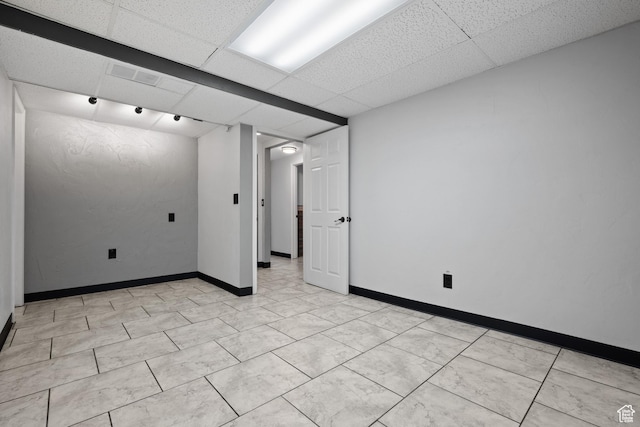 spare room with baseboards, visible vents, and a paneled ceiling