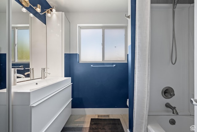 full bath featuring tile patterned floors, shower / bathtub combination with curtain, a wealth of natural light, and vanity