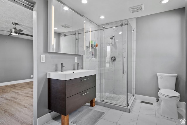 bathroom with recessed lighting, toilet, vanity, baseboards, and visible vents