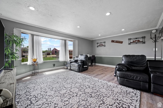living room featuring recessed lighting, wood finished floors, a textured ceiling, and ornamental molding