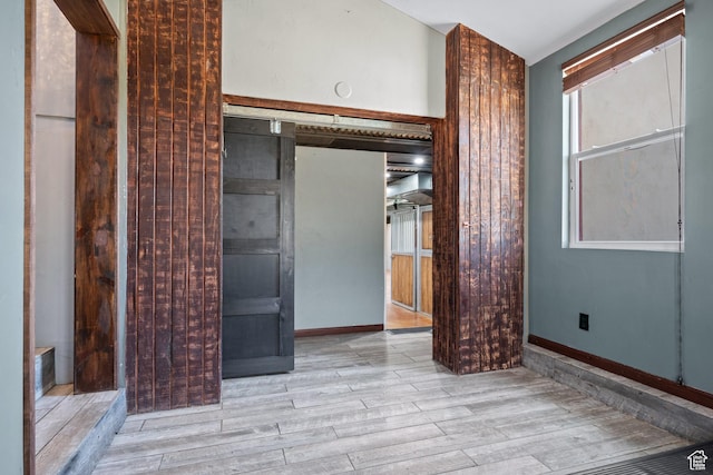 unfurnished bedroom with wood finished floors and baseboards