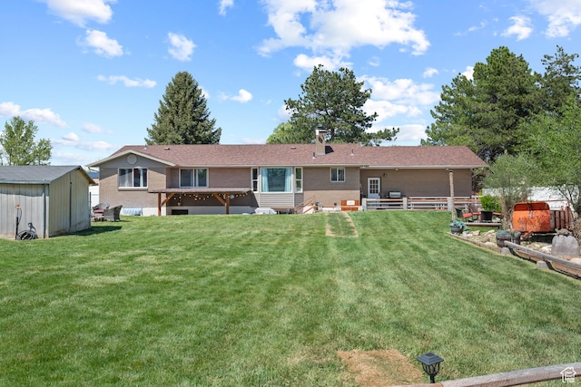 rear view of house with entry steps, an outbuilding, a storage shed, a lawn, and brick siding