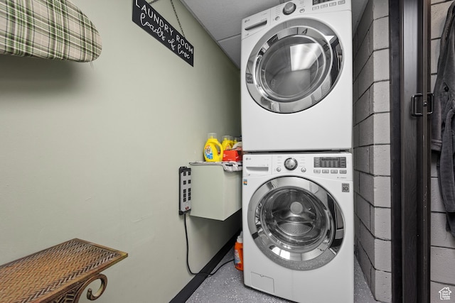 laundry area featuring stacked washer and clothes dryer and laundry area