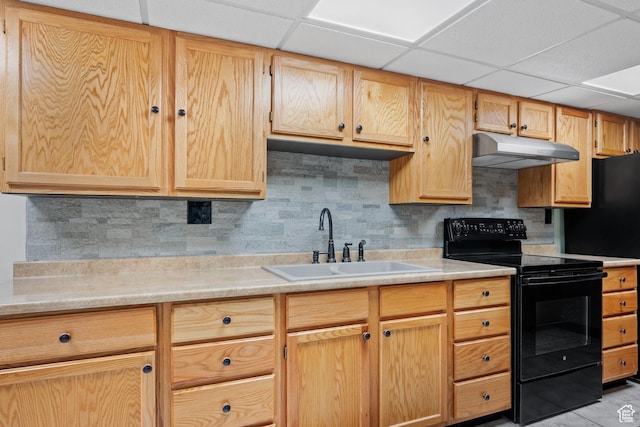 kitchen with a sink, under cabinet range hood, black range with electric stovetop, backsplash, and light countertops