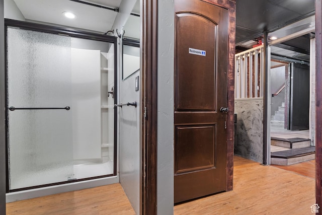 bathroom featuring wood finished floors and recessed lighting