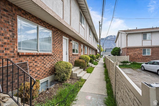 556 W 800 N Unit 15, Provo, UT 84601 - view of property exterior with brick siding, fence, and uncovered parking