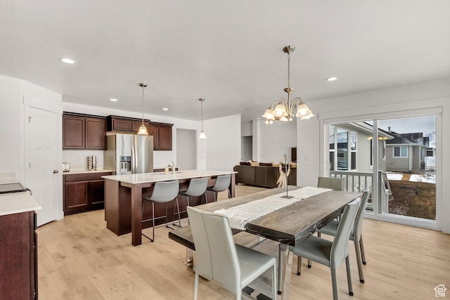 188 E Bruin Dr, Eagle Mountain, UT 84005 - dining area with light wood-style flooring, a chandelier, and recessed lighting