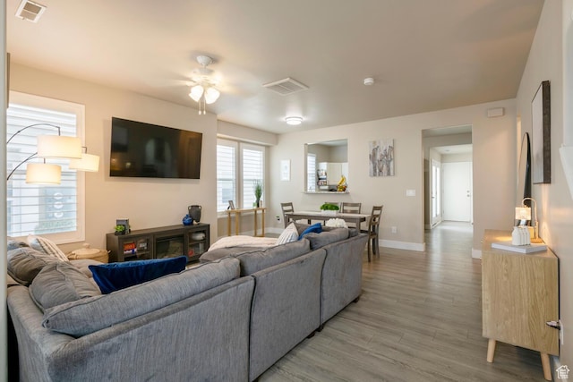 4947 W Calton Ln, South Jordan, UT 84009 - living area with light wood-style floors, ceiling fan, visible vents, and baseboards
