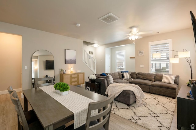4947 W Calton Ln, South Jordan, UT 84009 - dining space with visible vents, arched walkways, wood finished floors, a ceiling fan, and stairs